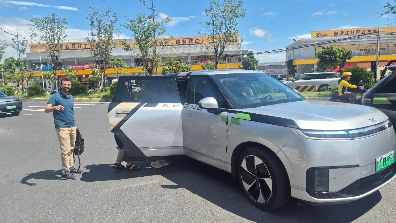 From robotaxis to private L4 cars: what a week in China taught us about the future of autonomous mobility 6 Study tour participant next to an XPENG passenger car before a test drive